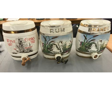 Three vintage porcelain hand painted Brandy, Rum and Wine barrels- damage to rum barrel. Measures approx 11 inches tall by 8.