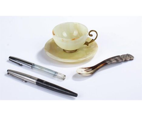 Jade cup and saucer, an onyx and horn spoon, and a Parker 45 fountain pen with another pen 