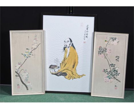 Japanese portrait of a sage wearing a yellow robe and holding a book and right hand raised in gesture, to include two floral 