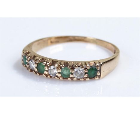 9 carat gold stone set ring, with emeralds and cubic zirconia