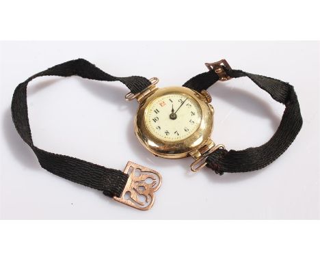 18 carat gold ladies wristwatch, with a white enamel dial and Arabic hours, manual wound