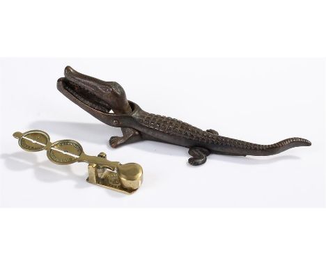 Brass sovereign scales and a crocodile nut cracker.