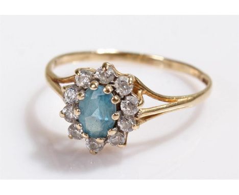 9 carat gold ring, with a central blue stone and surround to form a flower head