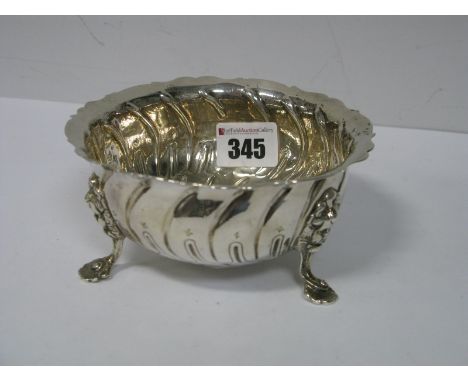 A Hallmarked Silver Dish, of shaped textured form raised on three cherub mask scroll pad feet, 13cm diameter, indistinctly st
