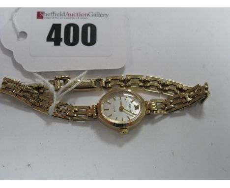 Accurist; A 9ct Gold Cased Ladies Wristwatch, the oval signed dial to 9ct gold gate style bracelet.