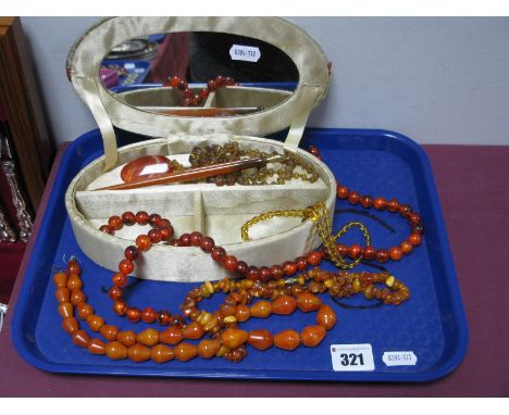 A Selection of Amber Coloured Bead Necklaces, other bead necklaces, amber coloured fountain pen, a hardstone oval panel, in o