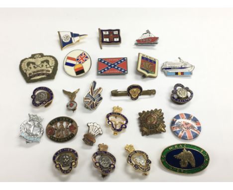 A small collection of metal and enamel badges comprising some military.