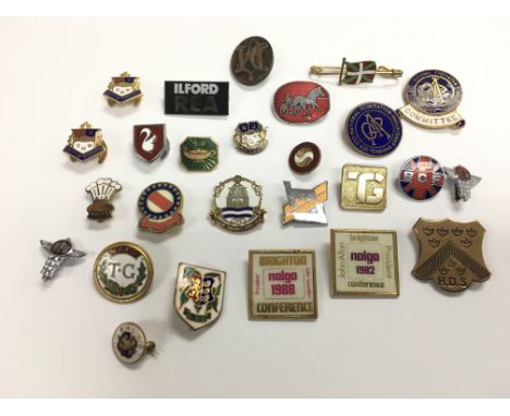 A collection of metal and enamel badges, various companies and associations.