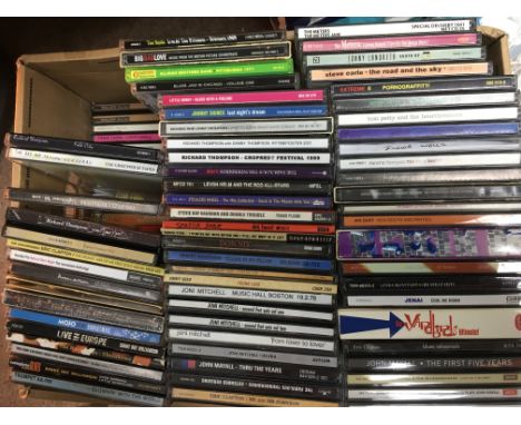 A box of CDs by various artists including Bob Dylan, Frank Zappa, The Band, Neil Young, Joni Mitchell and others.