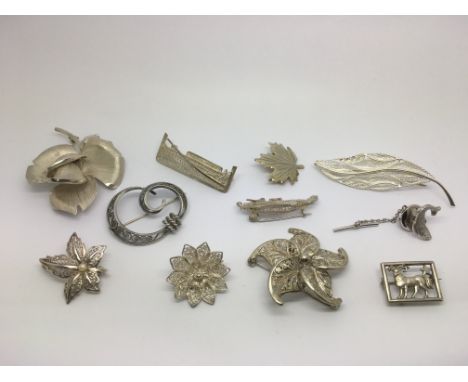 Eleven silver brooches, various designs.