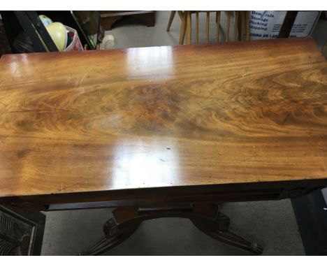 A Regency mahogany card table the twin flap top on a square column with shaped splayed legs.