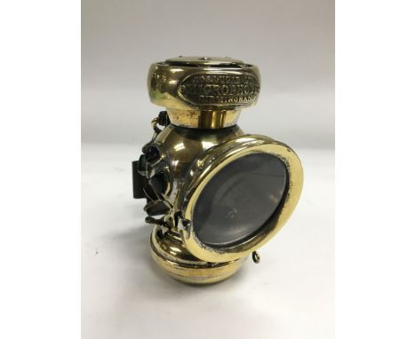 A Joseph Lucas Ltd 'microphote' oil bicycle lamp, circa 1900, approx 11cm high.