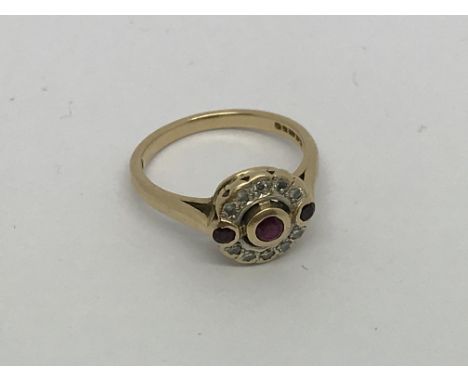 A 9ct gold ring set with ruby and diamond cluster. Size k/l approx weight 2.5g