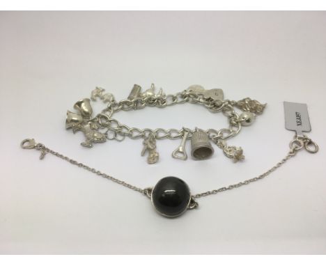 A silver charm bracelet and a beryl stone pendant in chain (2).