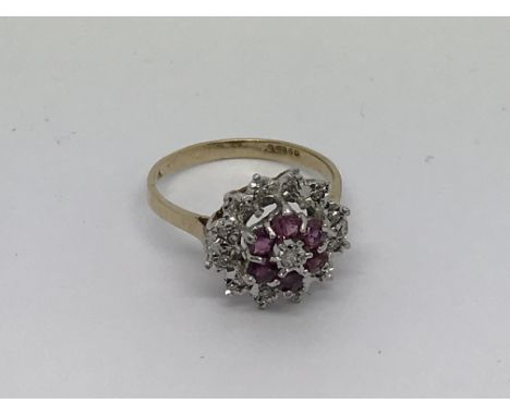 A 14ct gold ring set with ruby and diamond cluster. Size o approx weight 3g