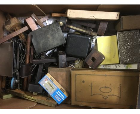 A box of tools together with a box of nuts and bolts .and two boxes of scales and weights .