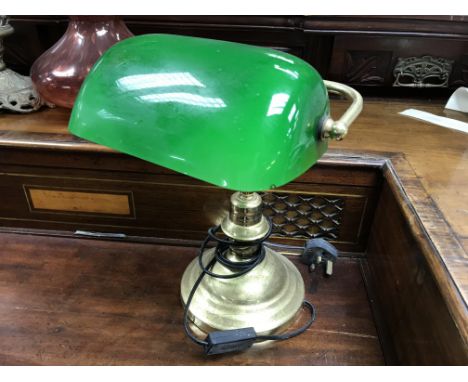 A brass and green glass desk light.