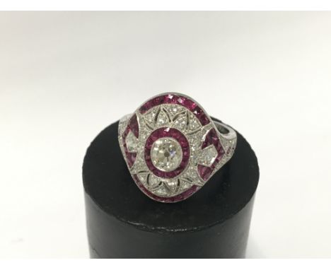 A Platinum and diamond 0.63ct old cut centre stone and ruby ring, N.