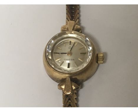 A Ladies 9carat gold omega watch with gold bracelet weight 13g manual wind seen working.