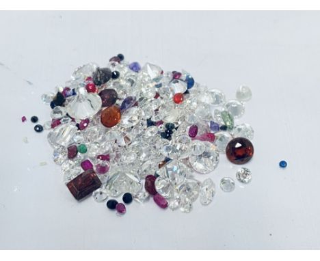 A bag of loose mixed gems inc, Ruby, Garnet, Sapphire and Peridot.