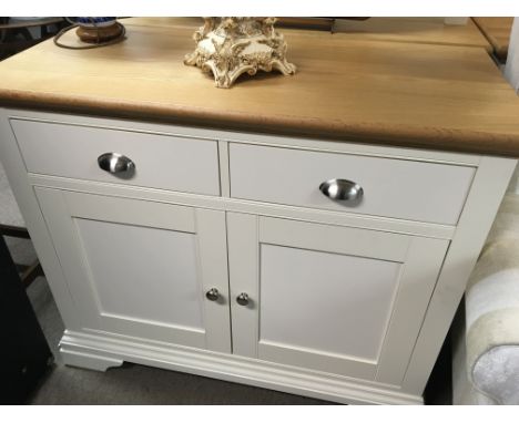 A modern white and light oak cabinet with a rectangular top above two drawers and cupboards 48x104cm
