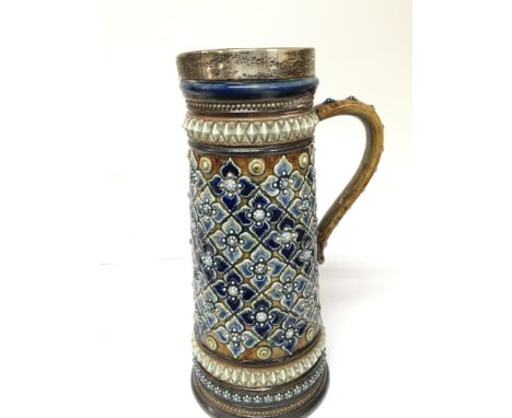 A Lambeth Doulton stoneware jug with raised decoration and a silver rim no damage Hight 21cm.