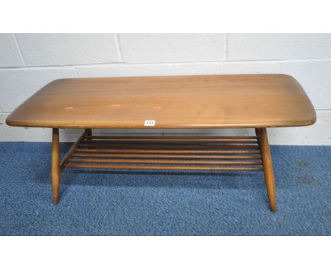 LUCIAN ERCOLANI, A MID CENTURY ERCOL ELM AND BEECH RECTANGULAR COFFEE TABLE, with rounded ends, raised on cylindrical tapered