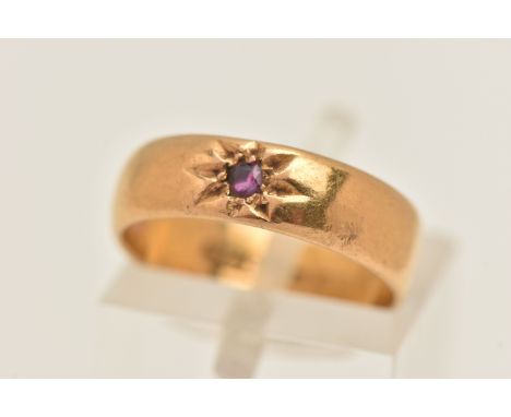 A 22CT GOLD RUBY SET BAND RING, wide band with a star set circular cut ruby, approximate band width 4.9mm, rubbed 22ct hallma