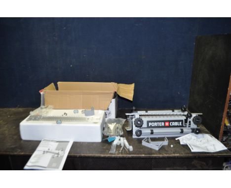 A PORTER AND CABLE DOVETAIL JIG in original packaging with 12in working width, two sets of fingers, clamps and brackets, thre