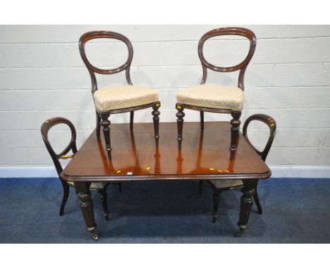 A 19TH CENTURY MAHOGANY WIND OUT DINING TABLE, with one additional leaf, raised on fluted and tapered legs, with brass caps a