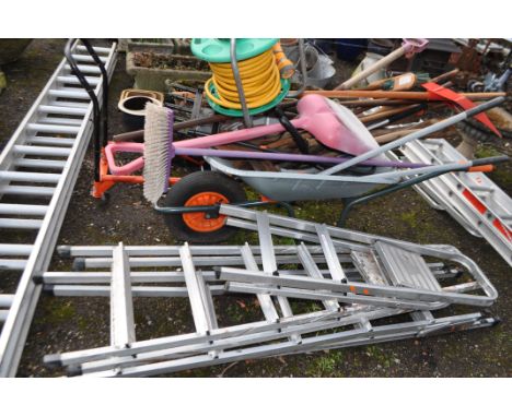 A BUILDERS WHEELBARROW GARDEN TOOLS AND STEP LADDERS (20+)