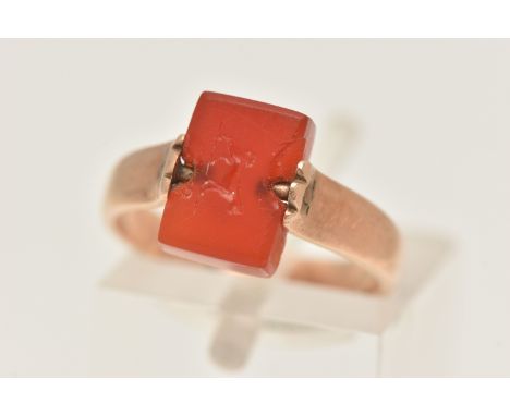 A LATE 19TH CENTURY CARNELIAN INTAGLIO SWIVEL RING, set with a rectangular carnelian panel carved with an initial monogram an