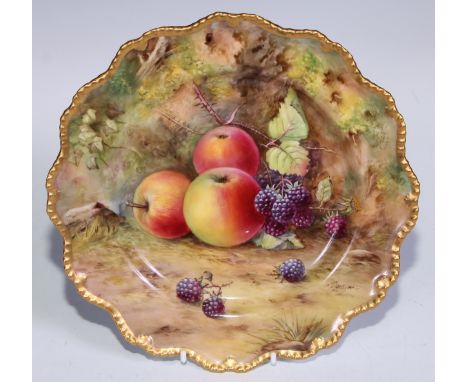 A Royal Worcester shaped circular plate, painted by T. Lockyer, signed, with ripe fruit on a mossy ground, gilt border, 22.5c