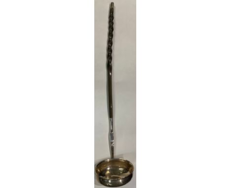 A Georgian silver toddy ladle, bearing a crest, baleen handle, 34cm long 