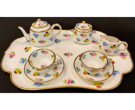 A Minton miniature cabaret set on tray, comprising teapot, sucrier and cover, milk jug, pair of cups and saucers, printed and