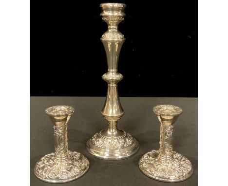 A pair of Elizabeth II silver boudoir candlesticks, Birmingham 1977; another silver candlestick, Birmingham 1971 (3) 