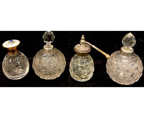 A cut glass scent with enamel cover; a silver mounted globular scent bottle; another, plated; an atomiser (4) 