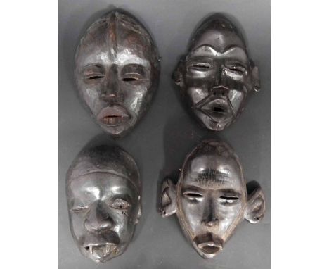 Three Dan masks and a Makonde mask, (4) the largest mask measures 24cm high     All lots in this Tribal and African Art Sale 