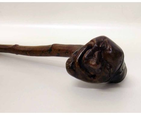 Walking stick made from tree root, the top featuring a grotesque face. Condition report: see terms and conditions