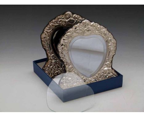 Two sterling silver mounted heart mirrors and a glass front Condition report: see terms and conditions
This lot is sold subje