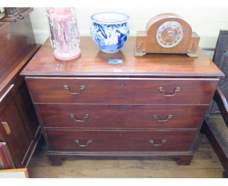 A George III mahogany bachelors dressing chest, the top with moulded edge over three long drawers and bracket feet, the top d