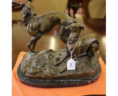 A bronze figure of two greyhounds playing, in the style of P.J. Mene, on a marble base, 28cm high