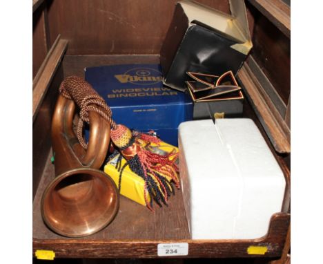 A copper bugle with silk tassles