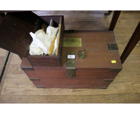 An oak and brass bound box with internal shelf, filled with Rowley Artists Oil Colours, the hinged lid with plaque inscribed 