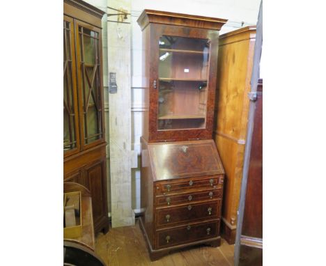 A George II style burr walnut and feather-banded bureau bookcase, the cavetto moulded cornice over a glazed door with candle 