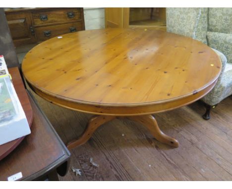 A pine breakfast table, the circular top on a tripod base of baluster stem and cabriole legs, 136cm diameter