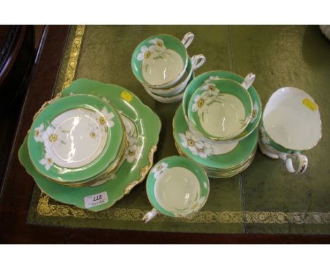 A Paragon Narcissus pattern part tea service, five cups, six saucers and plates, bread plate, sugar bowl and milk jug