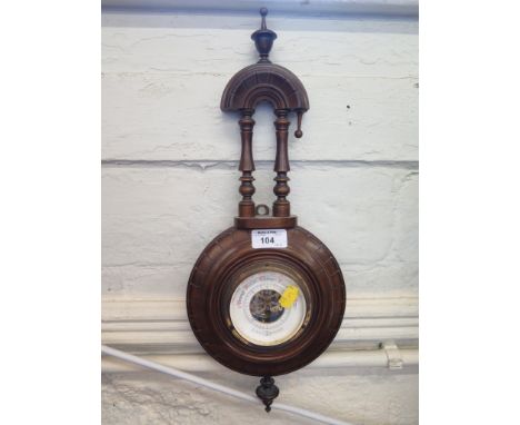 An Edwardian walnut aneroid barometer with turned finials and columns, 46cm high