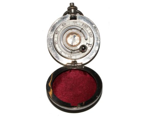 A white metal pocket compass and thermometer 