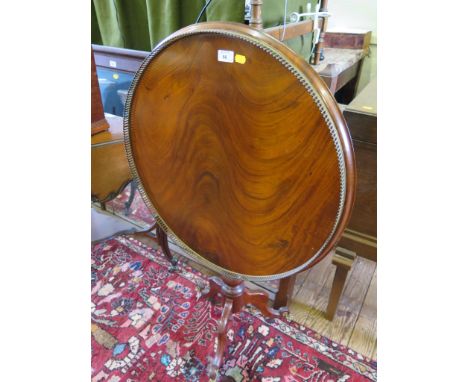 A 19th century continental style mahogany tripod table, the circular top with brass pierced gallery, birdcage hinge, turned c